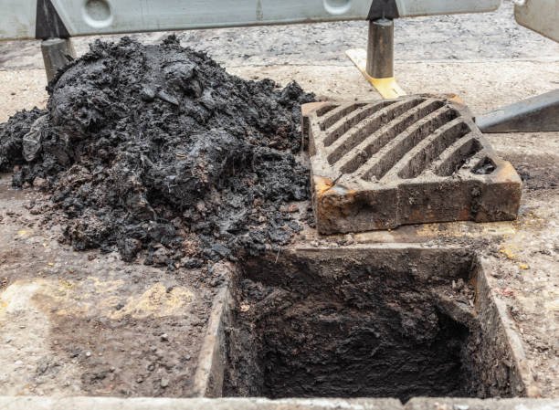 Work to remove material that was blocking a large drain on the street.
