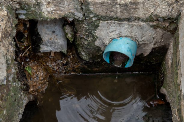 Blue PVC water pipe in dirty underground sewer for dredging drain tunnel cleaning selective focus