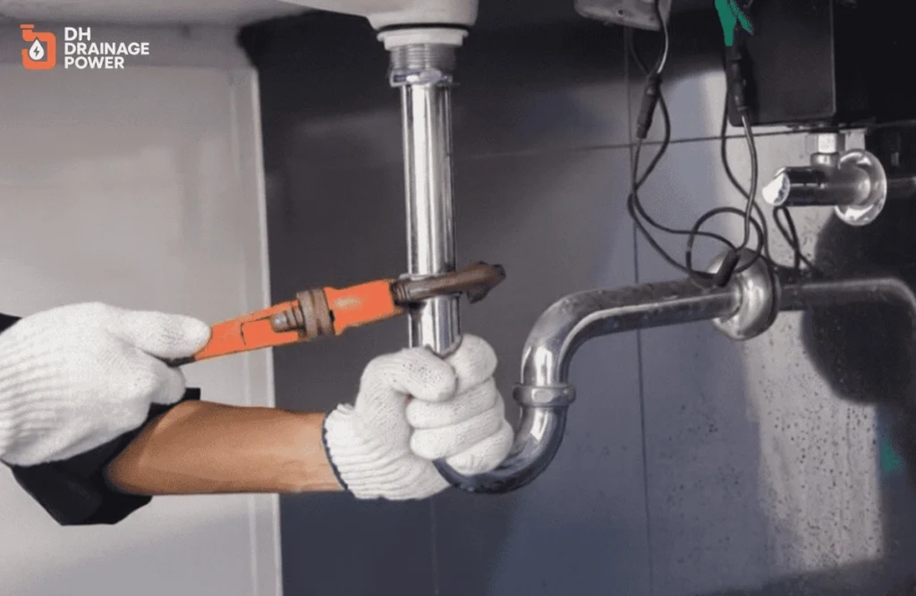 Emergency Kitchen Drains London engineer repairing blocked kitchen drain pipe